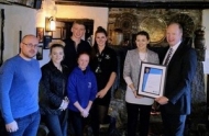Jamaica Inn is presented with an award for helping snow-bound motorists