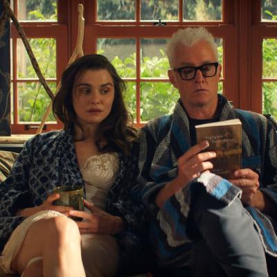 Rachel Weiss as the nameless narrator and John Slattery as her husband, John